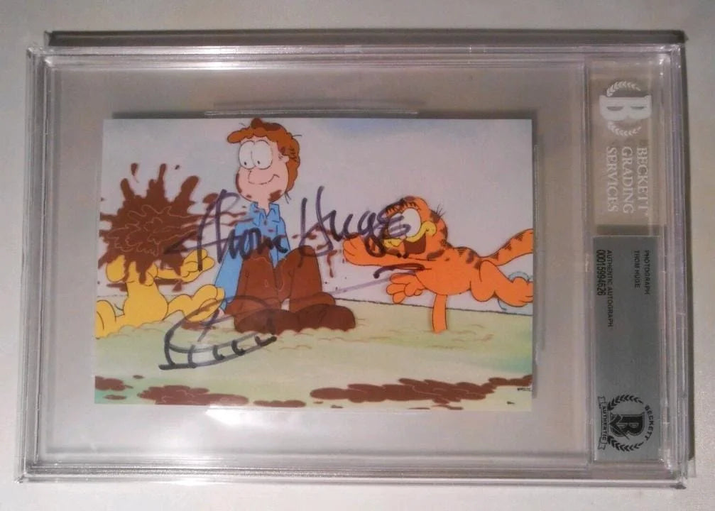Undated Garfield photograph featuring Jon Arbuckle and Garfield, signed by Jim Davis. Beckett authenticated autograph